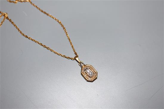 A modern yellow metal (stamped 750) and diamond set pendant, 13mm, on an unmarked yellow metal chain, gross 5.5 grams.